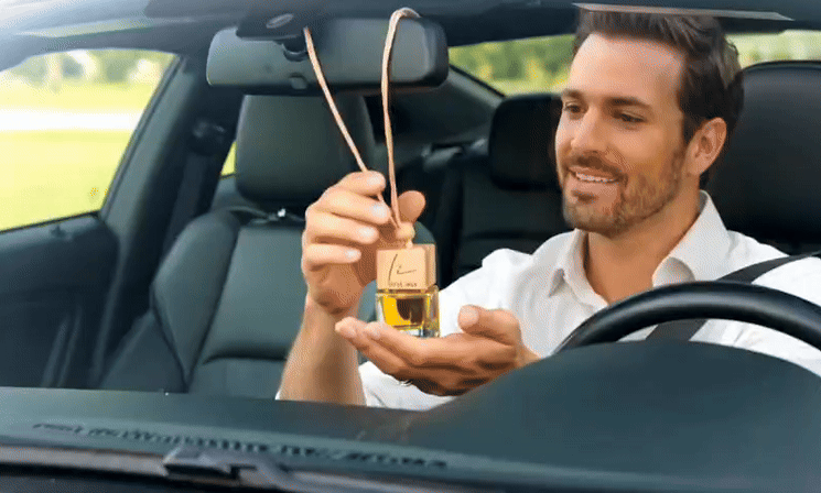 Hanging car air freshener diffuser in use